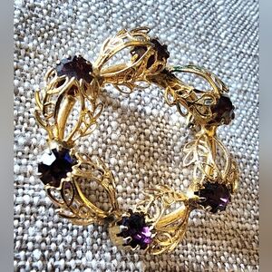 Rare Vintage amethyst color stones on a gold-toned wreath brooch.